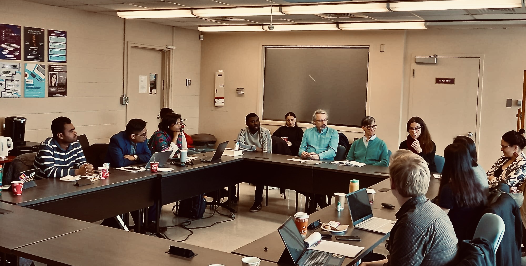 A professor speaking to a group of students